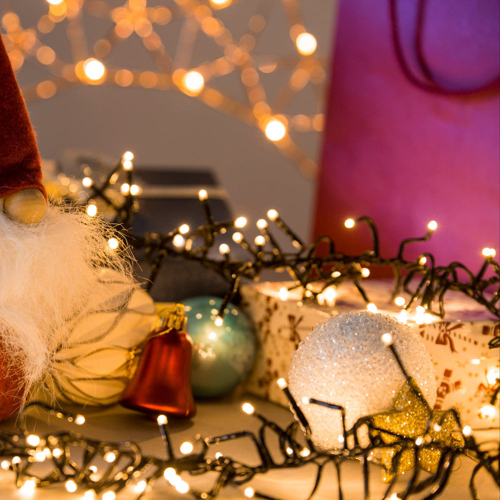 Decorative gnome with lights and ornaments on a blurred background
